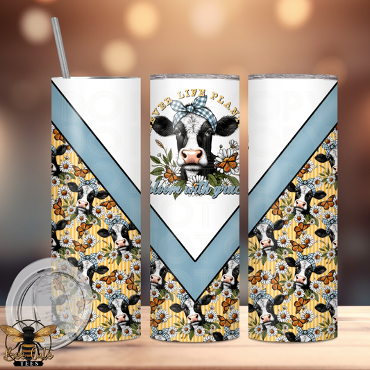 Three tumblers with cow and floral design on a wooden surface.