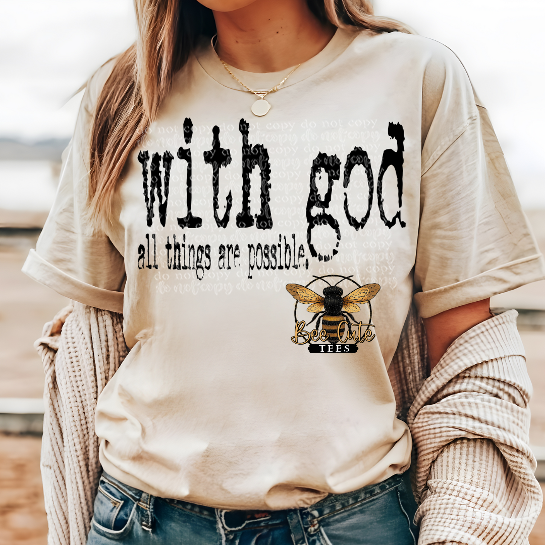 Person wearing a beige sweatshirt with 'with god all things are possible' text and a bee logo.