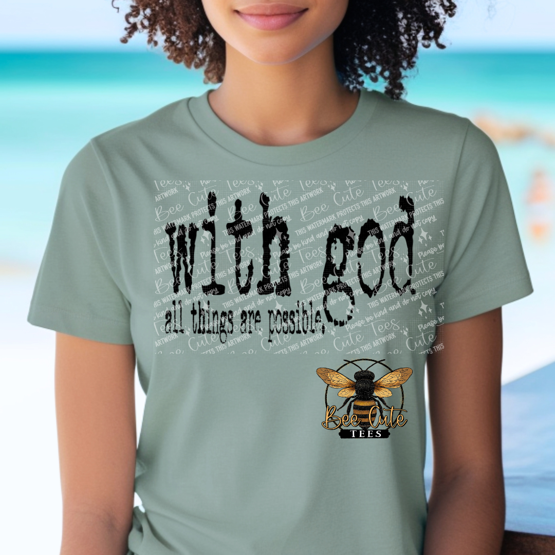 Person wearing a light green t-shirt with 'With God, all things are possible' text and a bee logo.