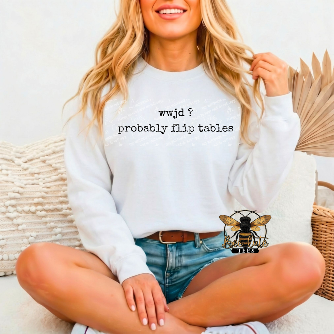 Person wearing a white sweatshirt with text sitting on a couch.