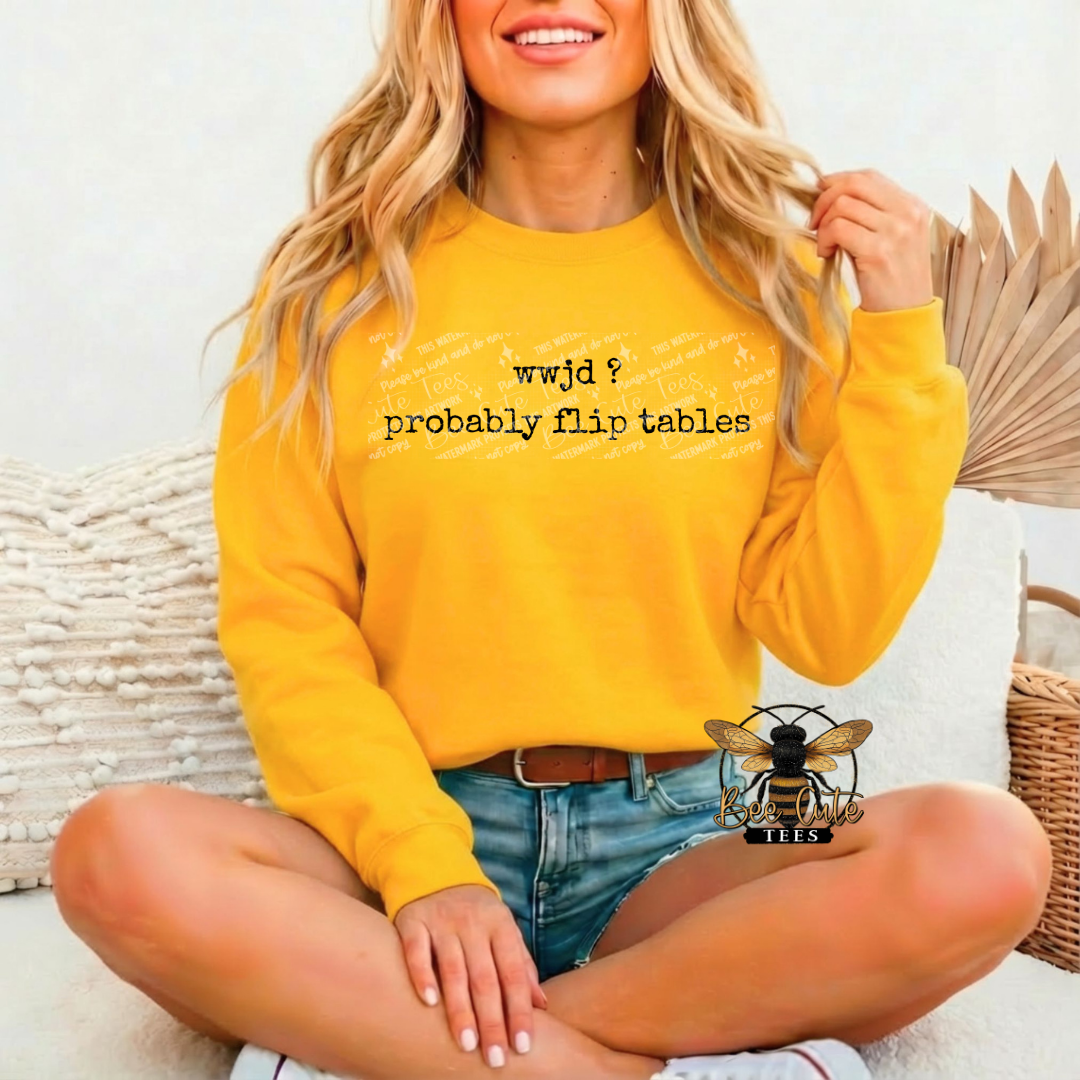 Woman wearing a yellow sweatshirt with text, sitting on a couch.