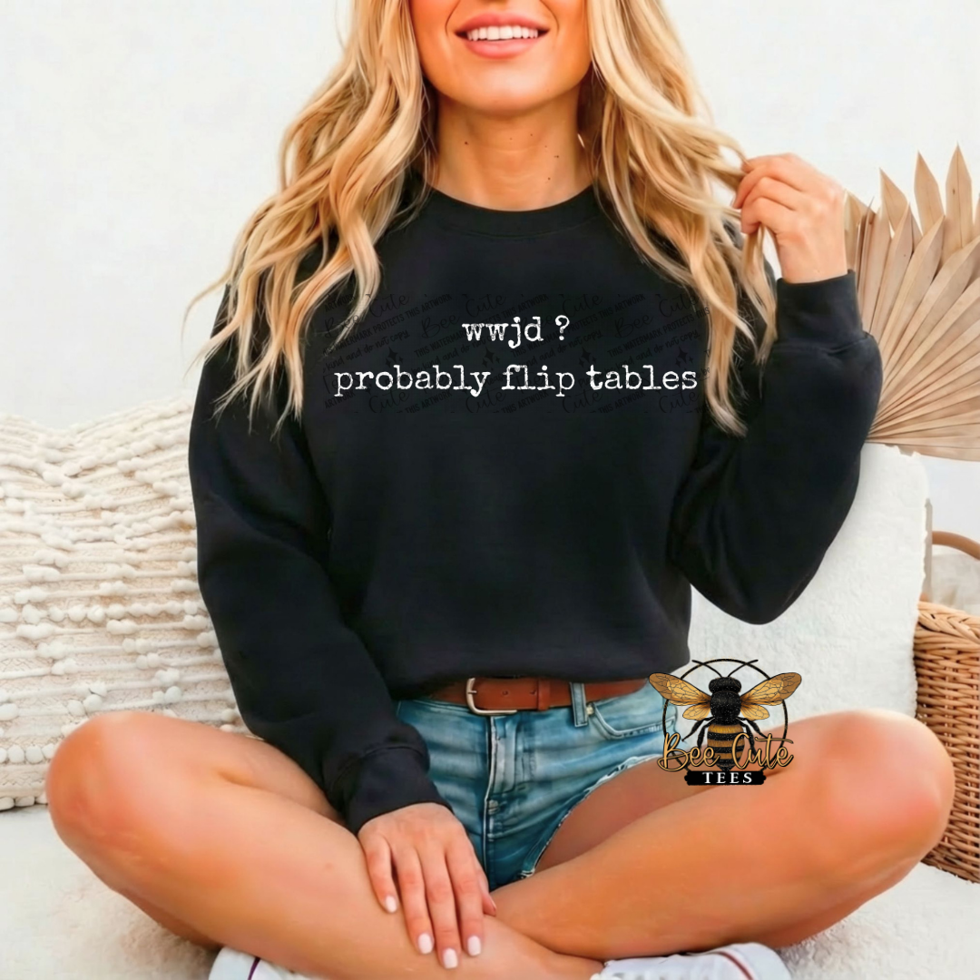 Woman wearing a black sweatshirt with text, sitting on a couch.