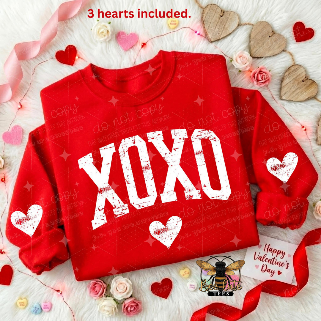 Red sweatshirt with 'XOXO' text on a decorative background with hearts and flowers.