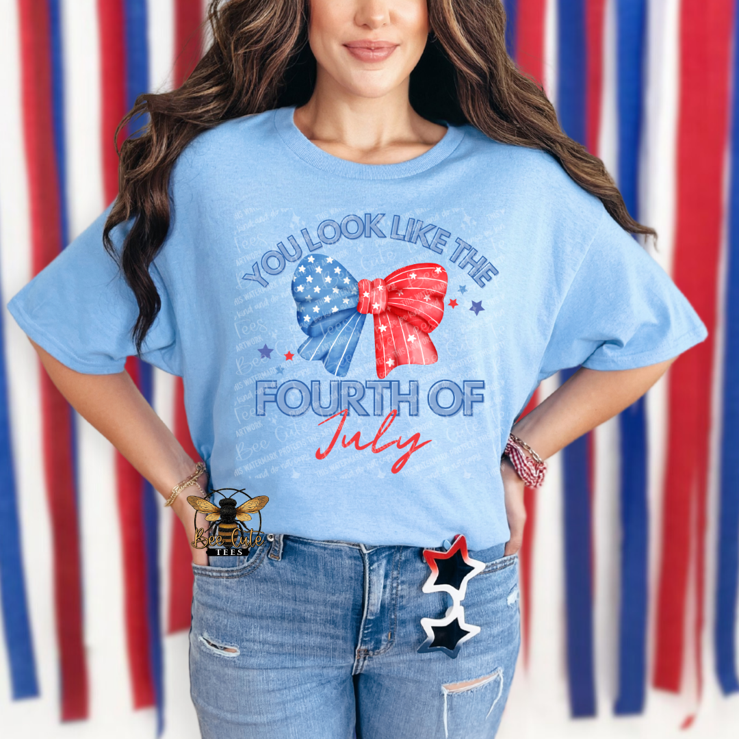Person wearing a blue t-shirt with a festive design in front of a red, white, and blue striped background.
